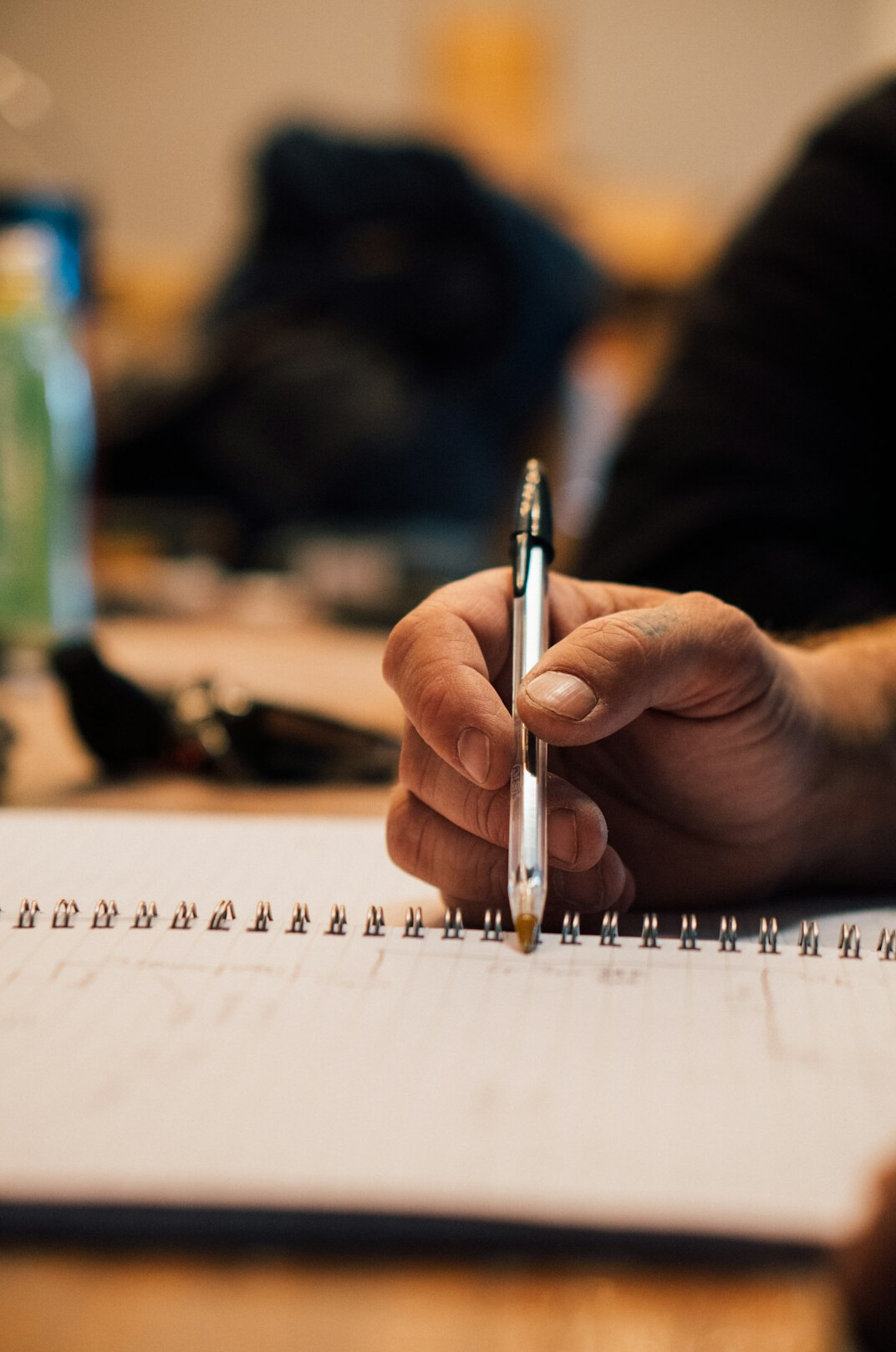 person writing goals in planner